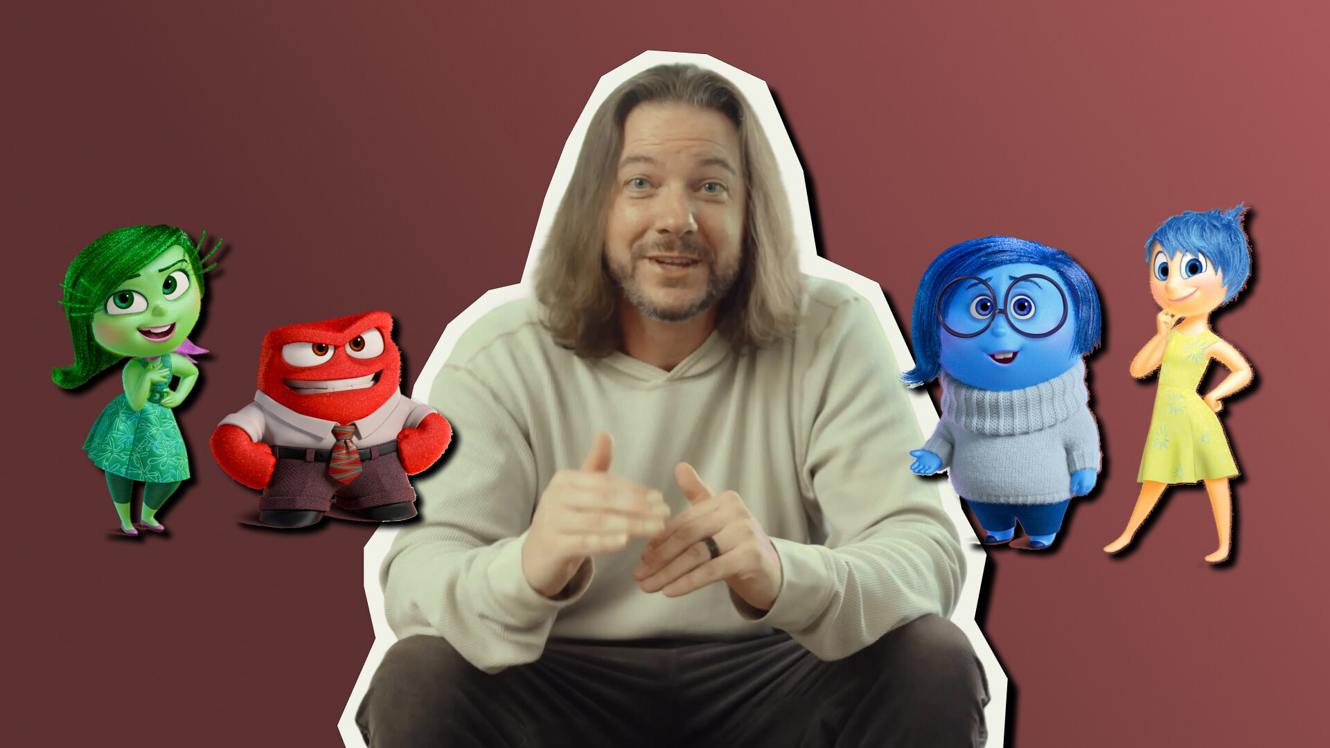 Chris Chandler seated among colorful emotion character illustrations